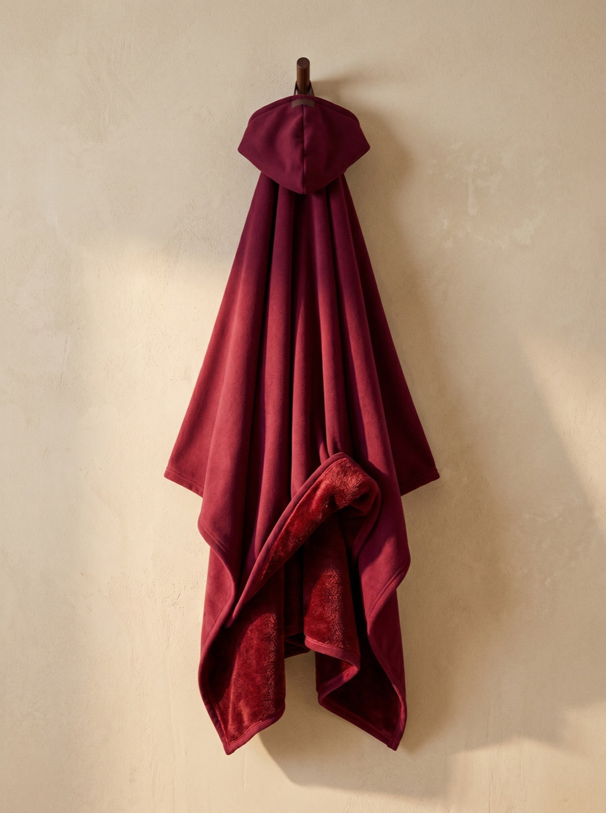 Enfold in Wine, corner folded to show the faux fur interior