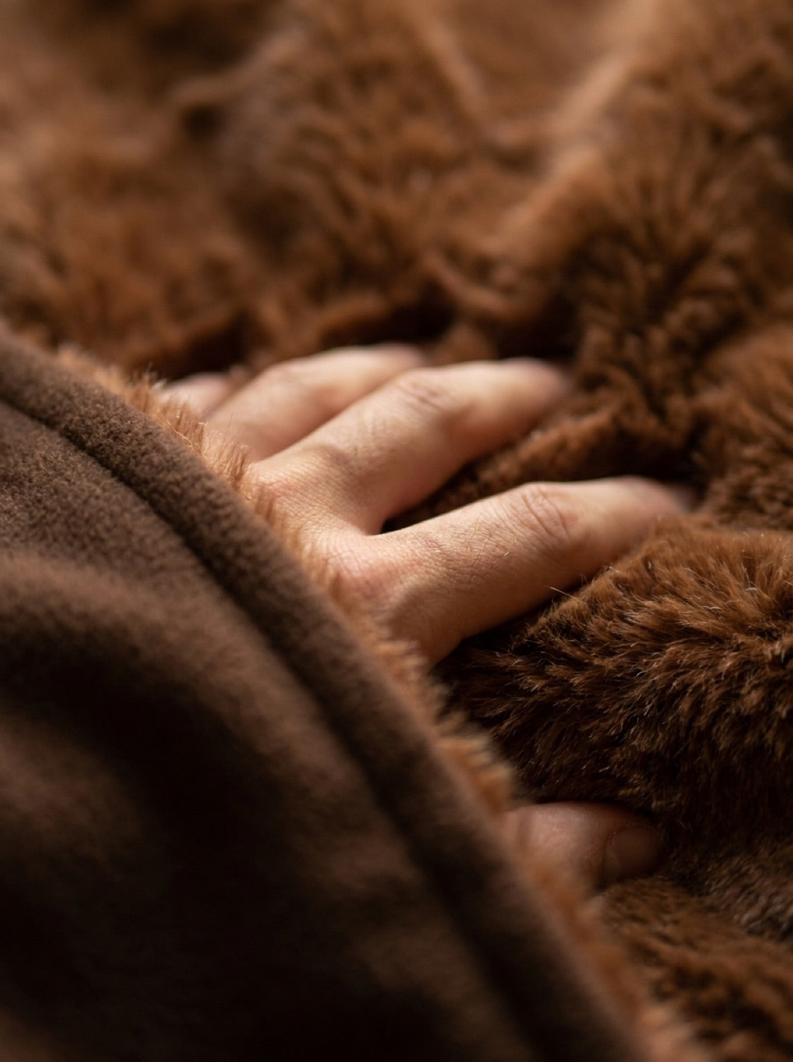 A hand sinking into the faux-fur interior of Enfold